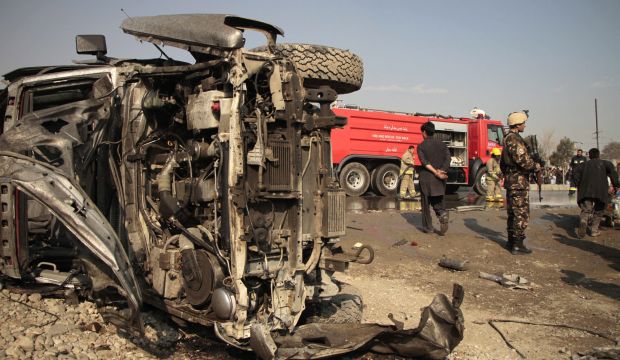 Afghan security officials inspect the scene of a suicide bomb attack on a British embassy vehicle in Kabul, Afghanistan, on November 27, 2014. (EPA/Hedayatullah Amid)