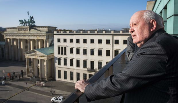 Mikhail Gorbachev enjoys the view of the Brandenburger Gate before attending a symposium on security in Europe 25 years after the fall of the Berlin Wall on November 8, 2014. (AFP Photo/Odd Andersen)
