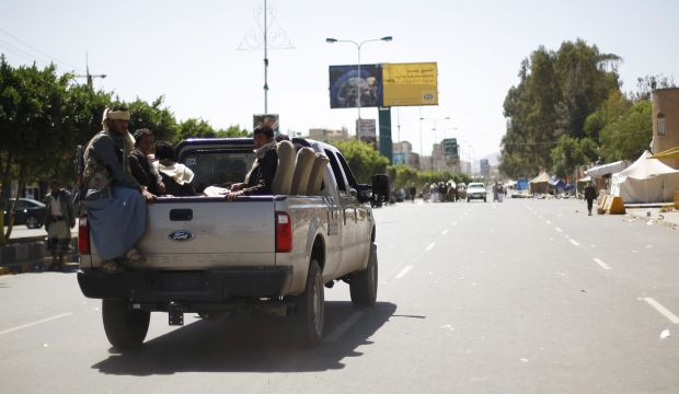 Houthi rebels riding on a pickup truck patrol a street while other members dismantle a protest camp on a road leading to Sana'a Airport in Sana'a, Yemen, on October 17, 2014. (AP Photo/Hani Mohammed)