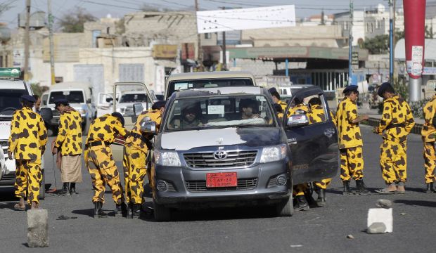 Houthi rebels in police uniform search cars at a checkpoint in Sana'a on November 4, 2014. (Reuters/Khaled Abdullah)