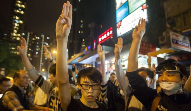 Pro-democracy protesters make the three finger freedom salute from the movie 'The Hunger Games' in Mong Kok, Hong Kong, on November 28, 2014. (EPA/Alex Hofford)