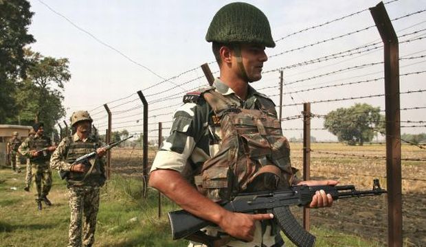 India's BSF soldiers patrol near the fenced border with Pakistan at the Wagah border. (Reuters)