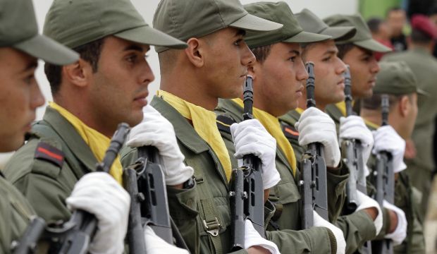 Soldiers stand to attention as the coffin of fellow soldier Zouheir Alkahli passes by during his funeral in Douar Hicher, near the capital Tunis, on November 6, 2014. (Reuters/Anis Milli)