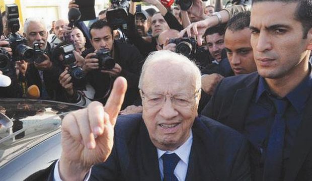 Presidential candidate and Nidaa Tounes party leader Beji Caid El-Sebsi leaves a polling station after casting his vote, during the first round of the Tunisian presidential election, in Soukra, outside the capital Tunis, on Sunday, November 23, 2014. (AP Photo/Mohamed Werteni)