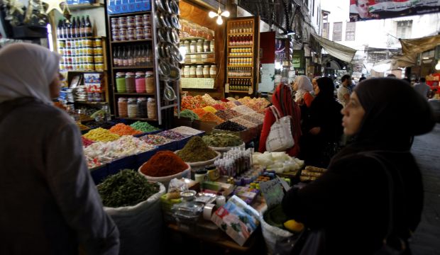 Syrians shop at stall selling herbs in Damascus, Syria, on October 14, 2014. (EPA/Youssef Badawi)