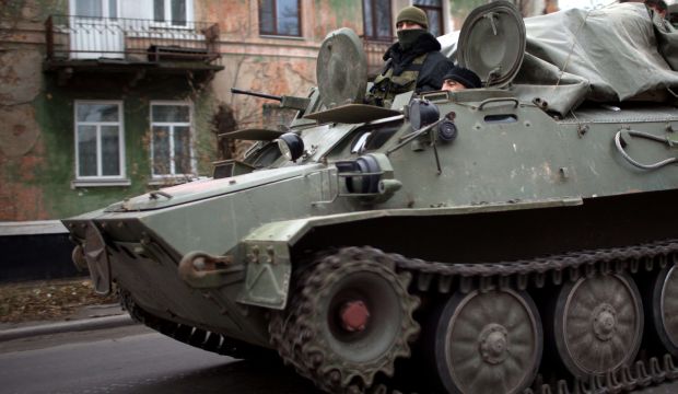 An armored personnel carrier enters rebel-territory east of Donetsk on November 12, 2014. (AFP Photo/Menahem Kahana)