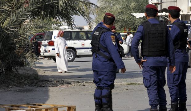 Policemen stand at the scene of bombing in Karzakan village, north of Bahrain, on December 9, 2014.(EPA/STR)