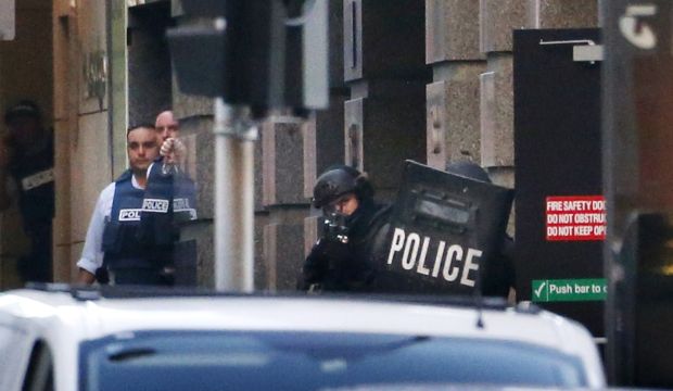 Police stand near the Lindt cafe, where hostages are being held, at Martin Place in central Sydney December 15, 2014.   (REUTERS/David Gray)
