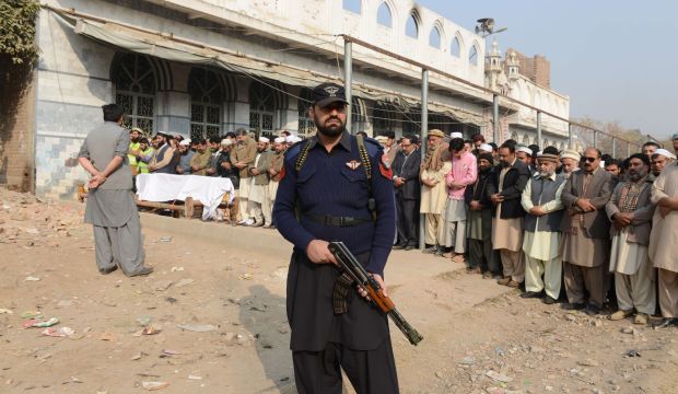 Pakistani mourners pray during the funeral ceremony for victims of an attack by Taliban militants at an army-run school, in Peshawar on December 17, 2014. (AFP PHOTO / A MAJEED)