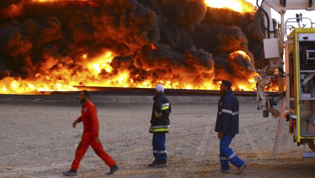 Firefighters try to put out a fire in an oil tank in Libya's Sidra port, on December 26, 2014. (Reuters Photos)