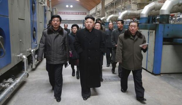 North Korean leader Kim Jong-un (Front-C) gives field guidance at the Kim Jong-suk Pyongyang Textile Mill in this undated photo released by North Korea's Korean Central News Agency (KCNA), in Pyongyang, on December 20, 2014. (Reuters/KCNA)