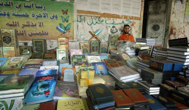 A Palestinian book seller stands by his stall selling copies of the Qur'an as well as other books, in Rafah, southern Gaza. (Said Khatib/AFP/Getty Images)