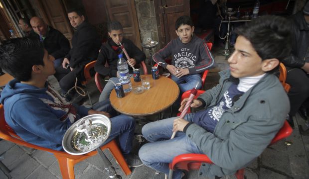 Syrian boys smoke water pipes at a cafe in the old part of the capital Damascus on January 16, 2014 as fighting continued in other parts of the country.  (Joseph Eid/AFP/Getty Images)