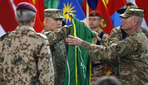 US General John Campbell (C), commander of NATO-led International Security Assistance Force (ISAF), folds the flag of the ISAF during the change of mission ceremony in Kabul, December 28, 2014. (Reuters/Omar Sobhani)