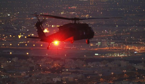 A Blackhawk helicopter flies support for US Defense Secretary Chuck Hagel over Kuwait City on December 8, 2014. (Reuters/Mark Wilson/Pool)