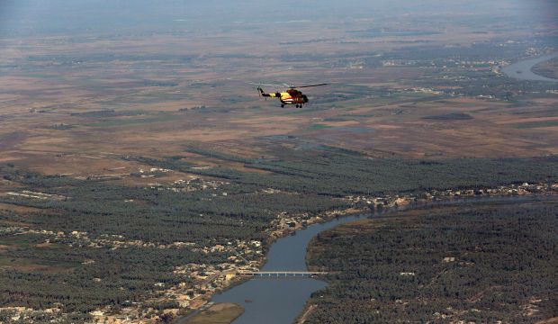 An Iraqi army helicopter flies over the city of Baaquba, the capital of Iraq's Diyala province, 35 miles northeast of Baghdad, Iraq. (AP Photo/Hadi Mizban)