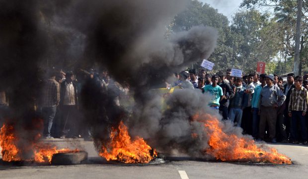 Activists of the Assam Tea Tribes Student Association (ATTSA) block the NH-52 road with burning tyres during a protest against the attacks on villagers by militants from the outlawed National Democratic Front of Bodoland (NDFB) in four locations, at Baghmari in the Sonitpur district of northeastern Assam state on December 24, 2014. (AFP Photo)