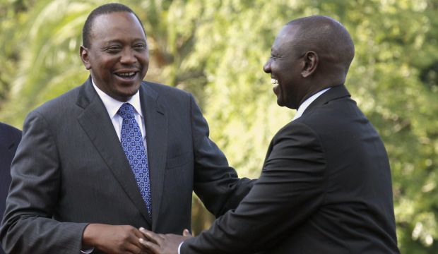 Kenya's President Uhuru Kenyatta (L) shares a moment with his deputy William Ruto after Kenyatta's case at the ICC was dropped, in Nairobi, on December 5, 2014. (Reuters/Thomas Mukoya)