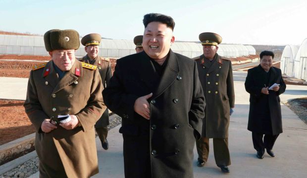 A picture released by North Korea's official Korean Central News Agency (KCNA) on 26 December 2014 of North Korean leader Kim Jong-un (C) reportedly touring a greenhouse at a military farm growing vegetables. (EPA)