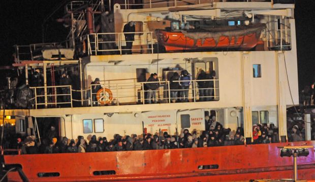 Hundreds of migrants are seen on board the decks of the Moldovan-flagged Blue Sky M cargo ship after it docked at the Italian port of Gallipoli in the early hours of December 31, 2014. (EPA/Biagio Claudio Longo)  