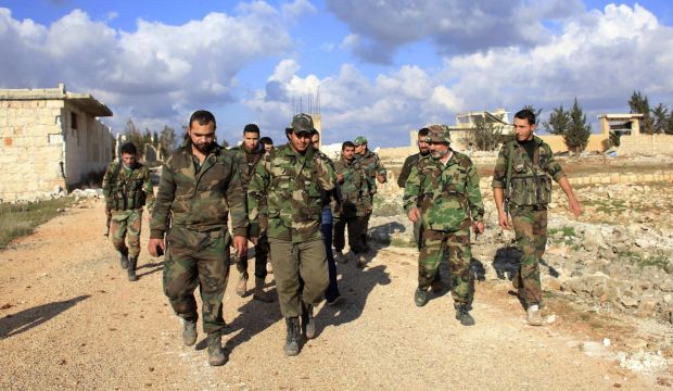 Forces loyal to Syria's President Bashar al-Assad walk in al-Mallah Farms after regaining control of the area in north of Aleppo December 15, 2014. (Reuters/George Ourfalian)