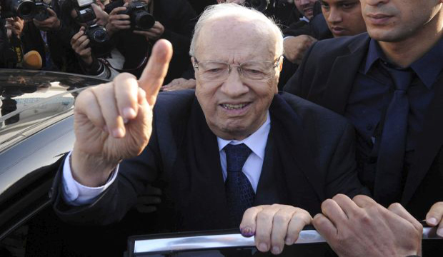 In this Nov. 23, 2014 file photo, presidential candidate and Nidaa Tounes party leader Beji Caid El-Sebsi leaves the polling station of Soukra after casting his vote, during the first round of the Tunisian presidential election. (AP Photo/Mohamed Werteni)
