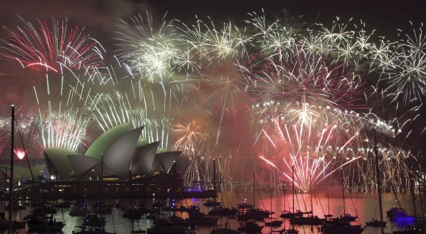 Fireworks explode over the Opera House and the Harbour Bridge during New Years Eve  celebrations in Sydney, Australia, on January 1, 2015. (AP Photo/Rob Griffith)
