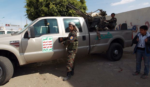 Members of the Shi'ite Houthi movement sit on a pickup truck mounted with a machine gun at a checkpoint in the Yemeni capital Sana'a on January 18, 2015. (AFP Photo/Mohammed Huwais)