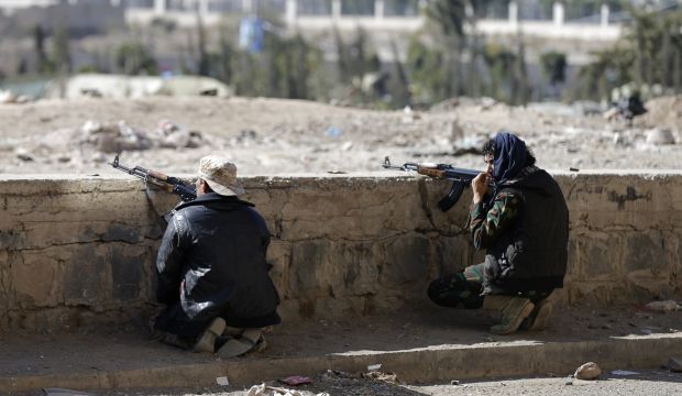 Houthi fighters take up position on a street during clashes near the Presidential Palace in Sana'a, on January 19, 2015. (REUTERS/Khaled Abdullah)
