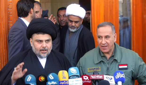 Iraqi Shi'ite cleric Moqtada Al-Sadr (L) speaks next to Iraq's Defense Minister Khaled Al-Obeidi (R) during a news conference in Najaf, south of Baghdad, on January 19, 2015. (REUTERS/Alaa Al-Marjani)