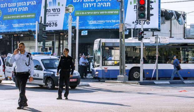 Israeli police stand at the scene of an attack after a Palestinian man stabbed passengers on a Tel Aviv bus on January 21, 2015. (AFP Photo/Jack Guez)