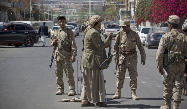 Houthi fighters wearing army uniforms stand guard on a street leading to the presidential palace in Sana'a, Yemen, on January 21, 2015. (AP Photo/Hani Mohammed)