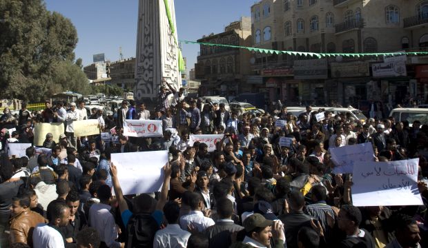 Protesters hold posters against Houthi Shi'ite rebels who hold the capital, Sanna, amid a power vacuum as they hold a demonstration in Sana'a on January 24, 2015. (AP Photo/Hani Mohammed)