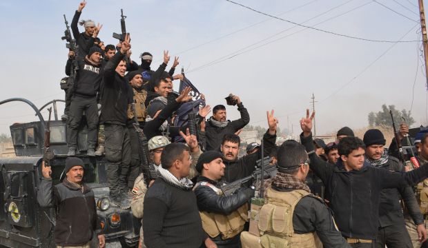 Iraqi government forces celebrate after they claimed they have gained complete control of the Diyala province, near the town of Muqdadiyah, on on January 26, 2015. (AFP Photo/Younis Al-Bayati)