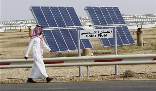 A Saudi man walks on a street past a field of solar panels at the Al-Oyeynah Research Station at the King Abdulaziz City of Sciences and Technology, in this May 21, 2012 file photo. (Reuters/Fahad Shadeed/Files)