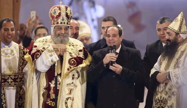 Egyptian President Abdel-Fattah El-Sisi (2nd R) talks next to Coptic Pope Tawadros II as he attends Christmas Eve Mass at St. Mark's Cathedral, the seat of the Coptic Orthodox Pope in Cairo, on January 6, 2015. (Reuters/ Al-Yawm Al-Saba'a Newspaper)