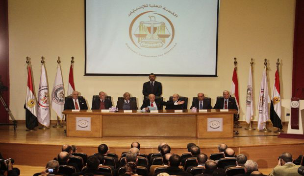 Ayman Abbas, the head of Egypt's Supreme Election Committee, center seated, speaks during a press conference in Cairo, Egypt, Thursday, Jan. 8, 2015. (AP Photo)