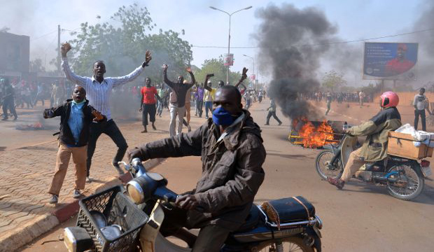 Smoke billows in a street as people demonstrate against French weekly Charlie Hebdo's publication of a cartoon of the Prophet Mohammed near the grand mosque in Niamey, on January 17, 2015. (AFP/Boureima Hama)