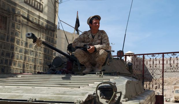 A Shiite Houthi militiaman wearing uniform confiscated from the Yemeni army sits on a government tank in the area around the presidential palace in the capital Sanaa, on January 22, 2015. (AFP/Mohammed Huwais)