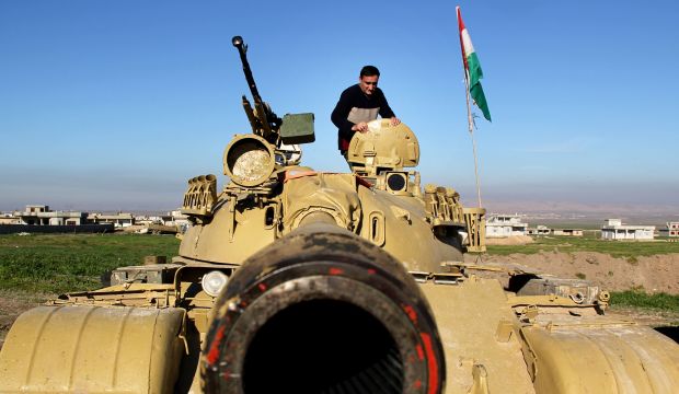 In this Tuesday, Jan. 20, 2015 image released by the Kurdistan Region Security Council (KRSC), A Kurdish peshmerga stands on a military tank preparing for battle against the Islamic State group in northern Iraq. (AP Photo)