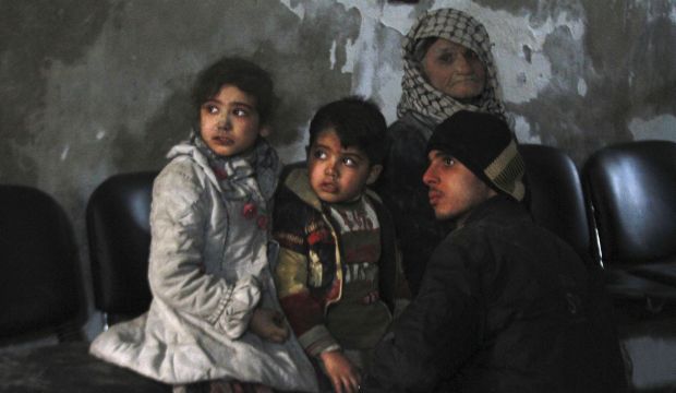 Injured children wait in a field hospital after what activists said was was an airstrike by forces loyal to Syrian President Bashar Al-Assad in the Duma neighborhood of Damascus on December 21, 2014. (Reuters/Badra Mamet)