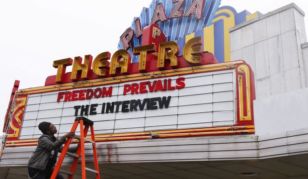 Theater manager Brandon Delaney changes the marquis of the Plaza Theatre after the cinema announced it would show the controversial movie 'The Interview' in Atlanta, Georgia, US, on December 23, 2014. (EPA/Erik S. Lesser)