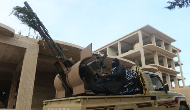 A member of Al-Nusra Front mans an anti-aircraft weapon near Zahra village, north of Aleppo, on November 25, 2014. (Reuters/Abdalrhman Ismail)