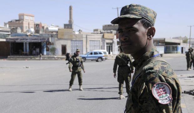 Members of the Shi'ite Houthi militia, wearing police uniforms, stand guard outside a hall where the movement is set to hold a tribal gathering in Sana'a, Yemen, on February 1, 2015. (EPA/STR)