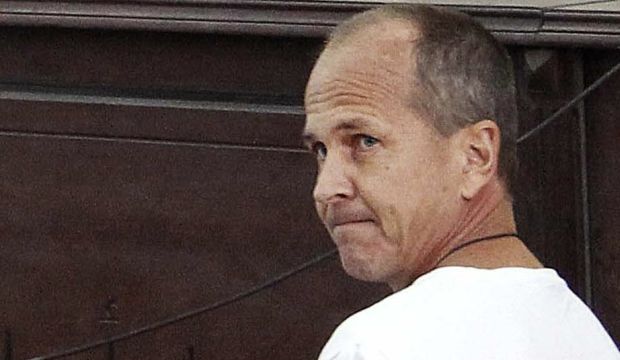 Al-Jazeera English correspondent Peter Greste appears in court along with several other defendants during their trial on terror charges, in Cairo, Egypt, on March 31, 2014. (AP Photo/Heba Elkholy, El Shorouk, File)