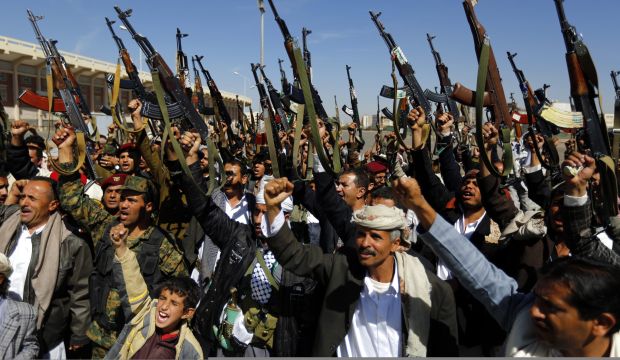 Tribal gunmen loyal to the Shi'ite Houthi movement shout slogans and hold weapons during a gathering in Sana'a, Yemen, on February 4, 2015. (EPA/Yahya Arhab)