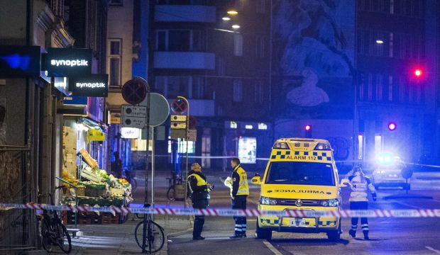 Emergency services personnel stand behind a police cordon on February 15, 2015, close to Norrebro station in Copenhagen, where the alleged offender of a terrorist attack, was killed. (AFP PHOTO / SCANPIX DENMARK / MARTIN SYLVEST)