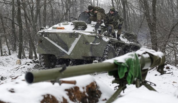 Ukrainian servicemen sit on an Armored Personnel Carrier (APC) at a checkpoint near the town of Svitlodarsk, Donetsk region, on February 16, 2015. (AFP Photo/Anatoli Stepanov)