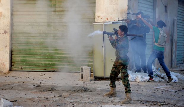 In this Wednesday, Oct. 29, 2014 file photo, Libyan military soldiers fire their weapons during clashes with Islamic militias in Benghazi. (AP Photo/Mohammed El-Sheikhy, File) 