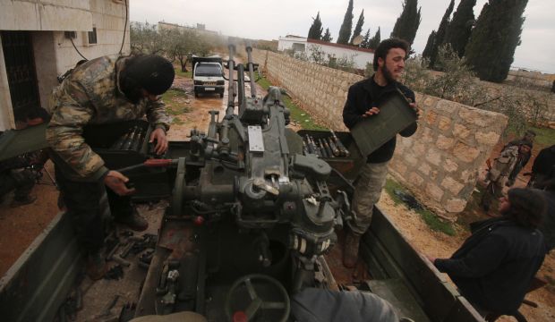 Syrian rebel fighters work on an anti-aircraft weapon mounted on a pick-up truck in Ratian, north of Aleppo, Syria, on February 18, 2015. (Reuters/Ammar Abdullah)